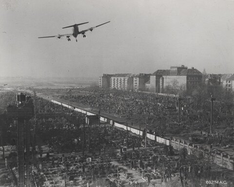 C-54_flies_over_rubble.original.jpg